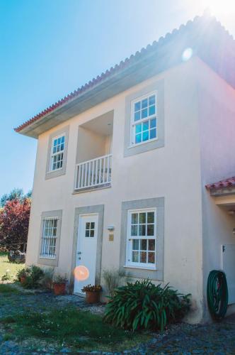 a white house with a white door and windows at Just like Home - Number 8 em Quinta das Mineirinhas in Vila Nova de Cerveira