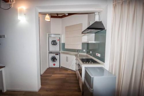 a kitchen with white cabinets and a stove top oven at Bougainvilla Colombo 10 in Colombo