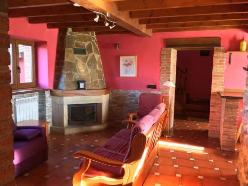 a living room with a couch and a fireplace at LA LLANADA in Cangas de Onís