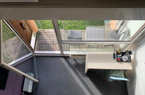 an overhead view of a room with a table and chairs at Hôtel L'ile Du Saussay in Itteville