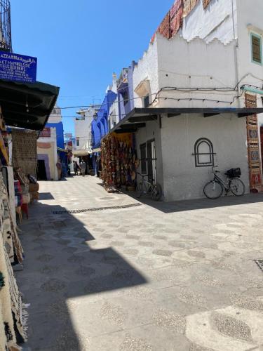 an alley with a bike parked next to a building at Dar Said in Asilah