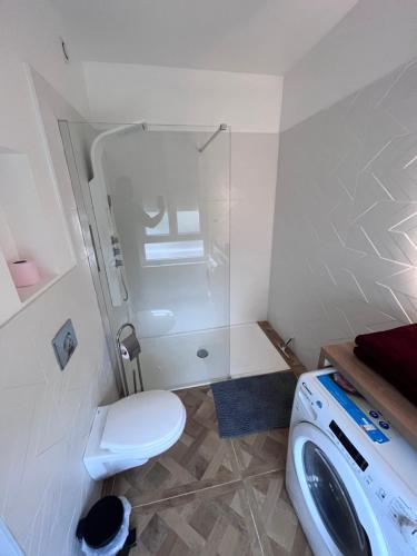 a small bathroom with a toilet and a sink at Le Lumineux in Le Havre