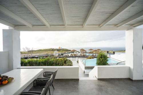 a view of the ocean from the balcony of a house at Oia Sunset Villas in Oia