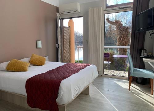 a bedroom with a bed and a view of a giraffe at Hôtel L'ile Du Saussay in Itteville