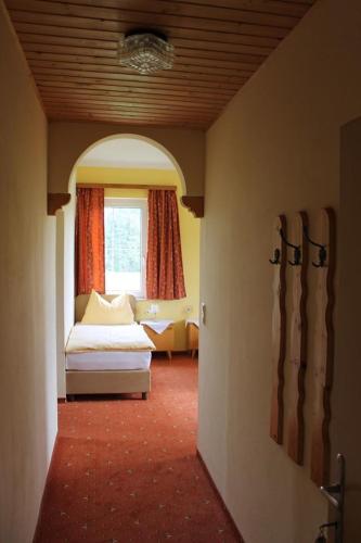 a living room with a couch and a window at Landhotel Gasthof Eichhof Natters in Innsbruck