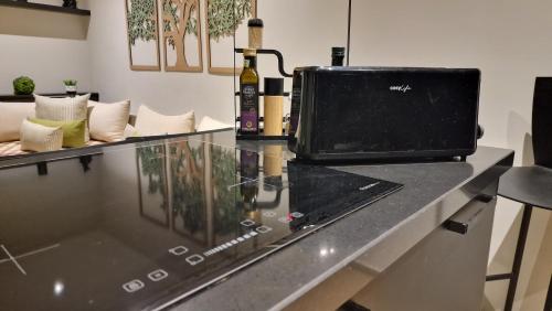 a counter with a bottle of wine and a laptop on it at Captivating 2-Bed Apartment in Tunis in Tunis