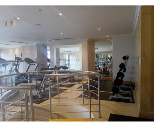 a gym with treadmills and elliptical machines at Michelangelo Towers 0801 in Johannesburg