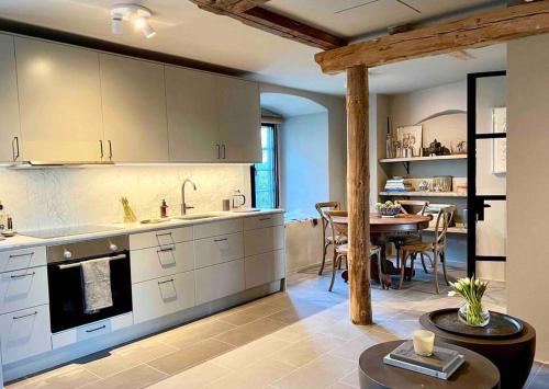 a kitchen with a table and a dining room at Castle Apartment in Österlen - The Thott Suite in Tomelilla