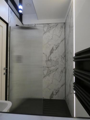 a shower with a glass door in a bathroom at Lorne View in Oban