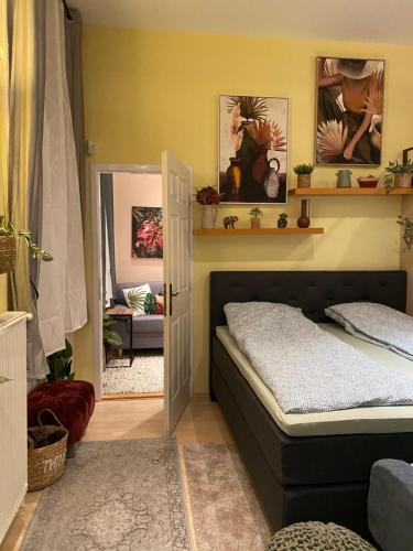 a bedroom with a bed and a mirror at Jungle Story Apartment by Millenaris Park with Free Parking in Budapest