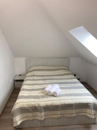 a bedroom with a bed with two towels on it at KRON HOUSE in Braşov