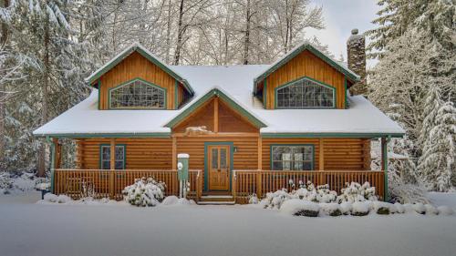 a log cabin in the snow with snow at Zigzag Mountain Lodge - Meredith Lodging in Rhododendron