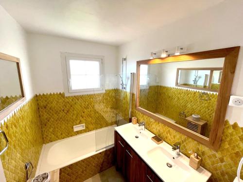 a bathroom with a sink and a mirror at Villa Harmonie - unique provençal charm in Antibes