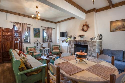 a living room with a table and a fireplace at Villa Dianne - Your Home in Mount Parnassos in Arachova