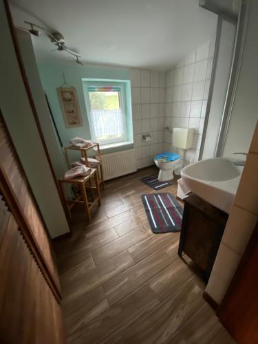 a bathroom with a tub and a sink and a toilet at Ferienhaus Zittau in Zittau