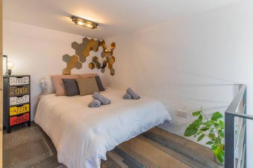 a bedroom with a bed with two stuffed animals on it at Unique studio loft, walking distance to Valletta in Hamrun