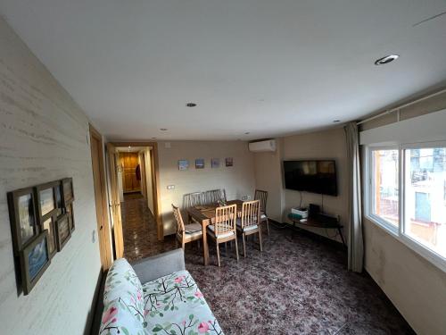 a living room with a table and a dining room at Great holiday apartment close to the beach in Gandía