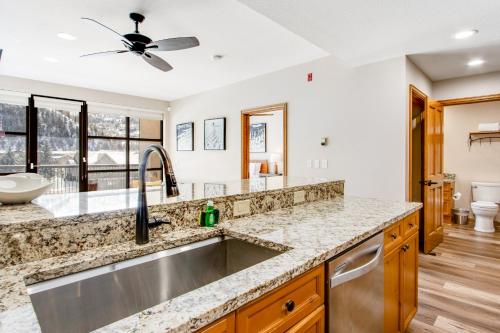 a kitchen with a sink and a ceiling fan at Chapel Place in Avon