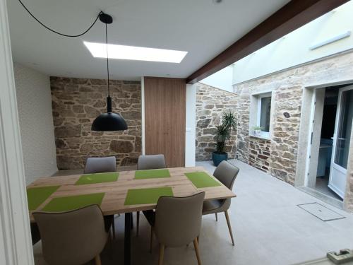 a dining room with a wooden table and chairs at Casa a Antiga Tenda in Santiago de Compostela