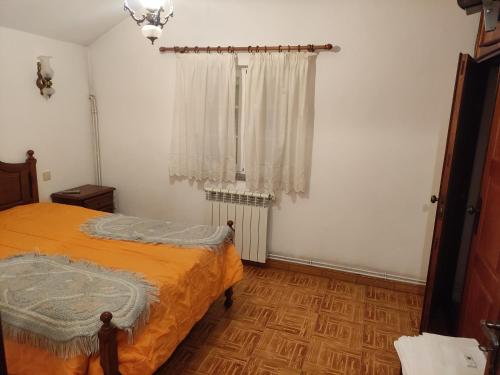 a bedroom with a bed and a window at Casa do Serrinho in Seia