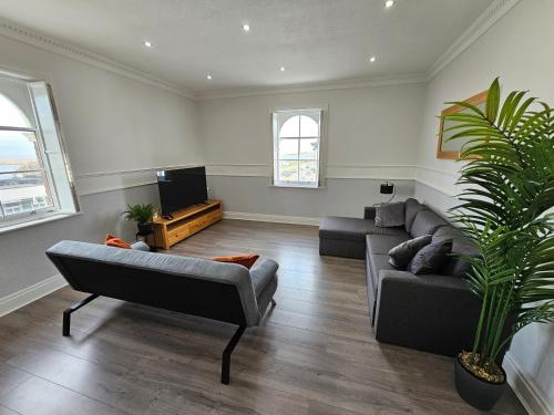 a living room with a couch and a tv at Lakeview Apartment, central location, Sea and Lake view, free parking & WiFi in Southport