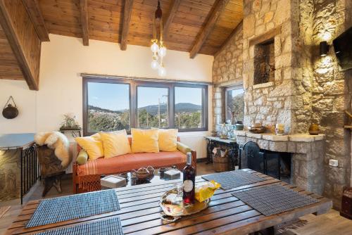 a living room with a couch and a fireplace at Villa Dianne - Your Home in Mount Parnassos in Arachova
