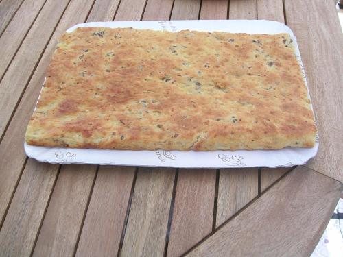a casserole in a white dish on a wooden table at B&B La Terrazza Del Subasio in Assisi