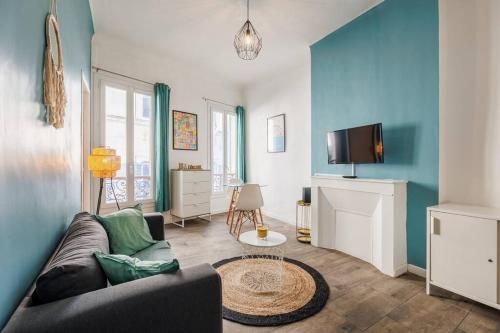 un salon avec un canapé et une télévision dans l'établissement Au coeur du panier T2 climatisé et tout équipé, à Marseille