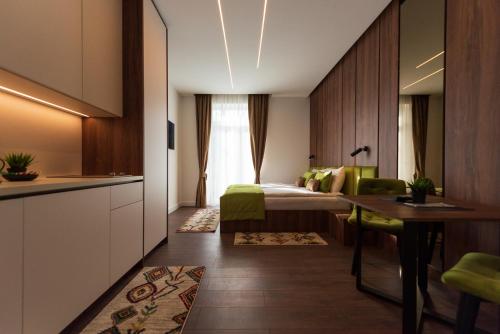 a hotel room with a bed and a desk at Apartments EMERALD Free Garage Parking in Sarajevo