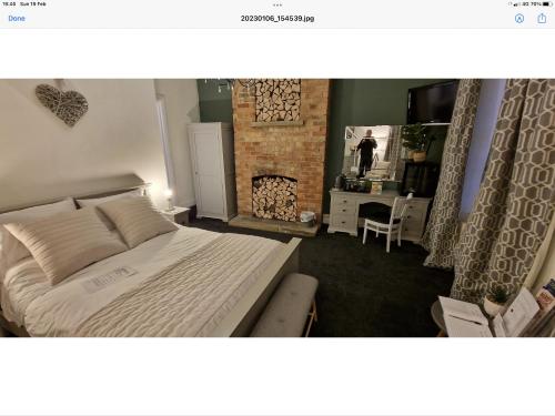a bedroom with a bed and a fireplace at Beautiful apartment in Sleaford in Sleaford