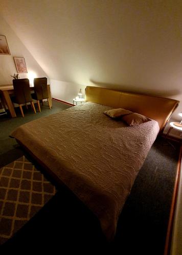 a large bed in a bedroom with two chairs at Schöne Doppelzimmer in Rheine