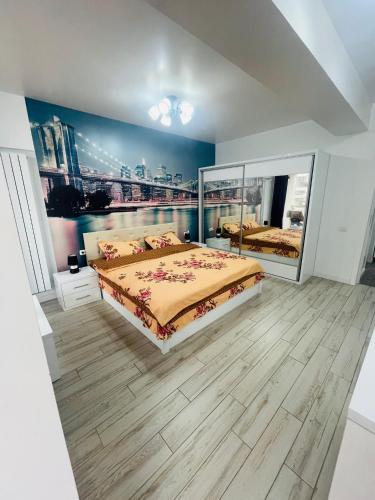 a bedroom with a large bed and a painting on the wall at DEEA Residence in Mamaia
