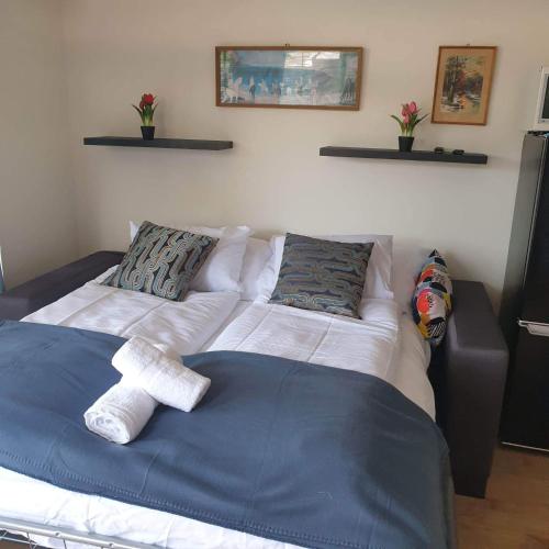 a bedroom with a bed with a teddy bear on it at Magyartenger Apartman Balatonlelle in Balatonlelle