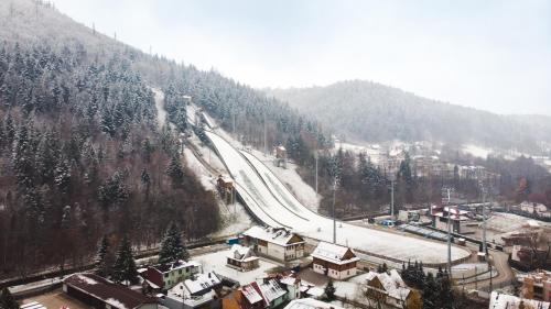 a snow covered mountain with a road on it at ApartView Plażowa Residence Szczyrk by Rent like home in Szczyrk