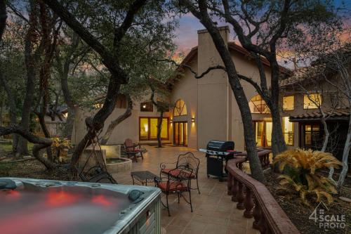 a house with a patio and a grill at Villa Española in San Antonio