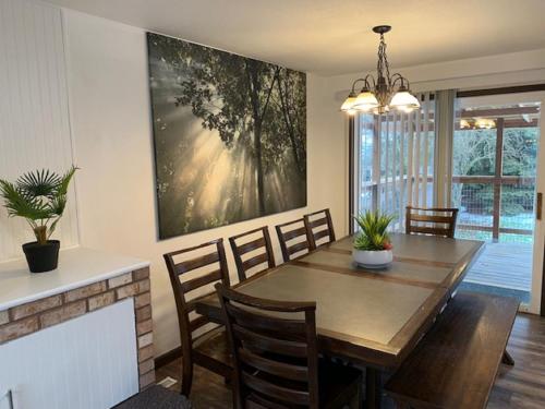 a dining room with a table and chairs and a fireplace at Outdoor Sanctuary - 3 min walk to Silver Mtn in Kellogg