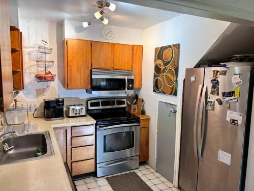 a kitchen with a stove and a refrigerator at MountForest in Shoreline
