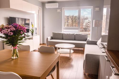 a living room with a couch and a table at Marywilska apartment in Warsaw