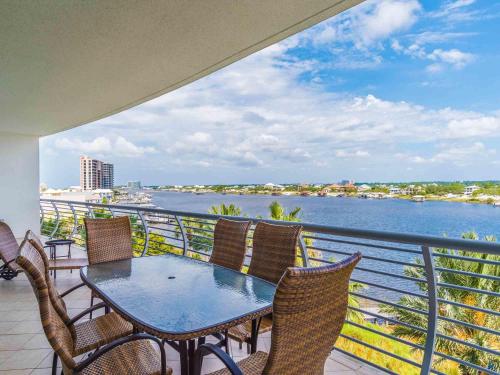 a table and chairs on a balcony with a view of the water at Bella Luna #404 in Orange Beach