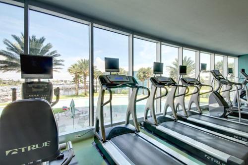 a row of treadmills in a gym with a large window at Bella Luna #404 in Orange Beach