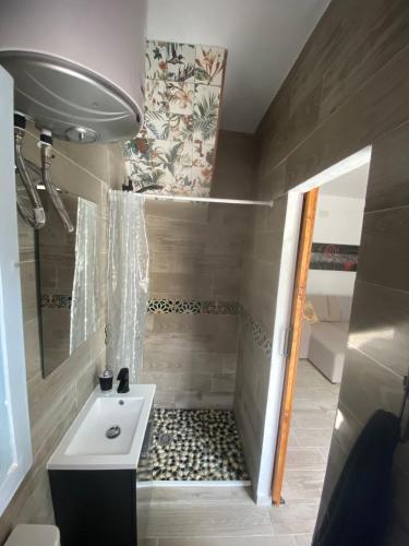 a small bathroom with a sink and a shower at Mi pequeño refugio in Constantina