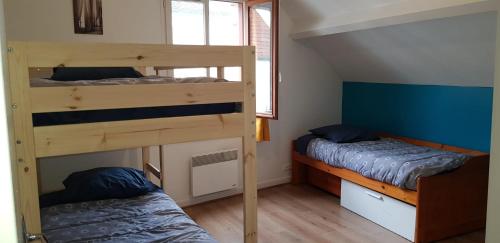 two bunk beds in a small room with two beds at Tranquil House 10min from Disneyland Paris in Bussy-Saint-Georges