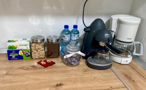 a counter with a coffee maker and other items on it at EDA apartment in Bistriţa