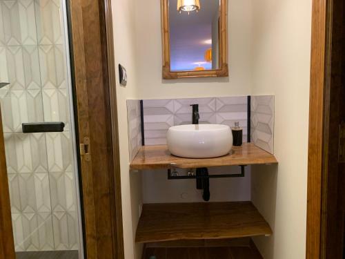 a bathroom with a sink and a mirror at "CHALET A ESTRENAR" MIRADOR DE LA VENTOSA-Potes in Ojedo