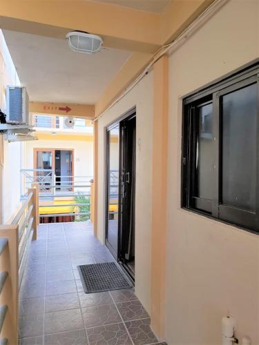 a hallway of a house with a balcony at Beach Side Condos Caye Caulker by CCVH in Caye Caulker