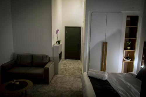 a living room with a bed and a couch at Magnolija Apartments in Bitola