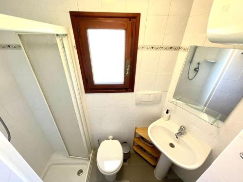 a small bathroom with a toilet and a sink at Historic Downtown Home By The Sea With King Bed in Monterosso al Mare