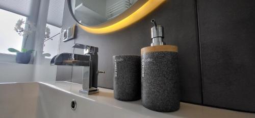 a bathroom with a soap dispenser on a sink at KLIF 4 panorama Warki in Warka