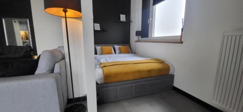 a small bedroom with a bed and a window at KLIF 4 panorama Warki in Warka