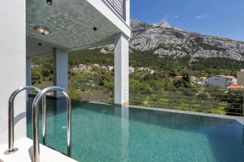 a swimming pool with a view of a mountain at Villa Teraco in Makarska